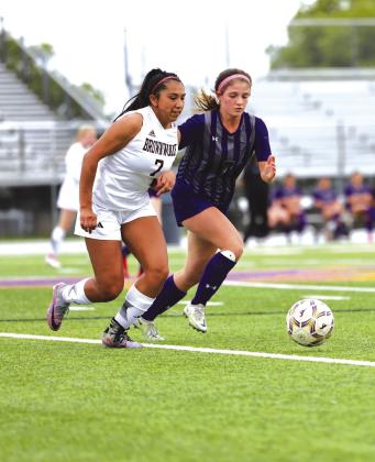 Marble Falls' Cali Brydon is in a foot race for the ball for the win against Brownwood March 20. Contributed/Ernesto Rivera