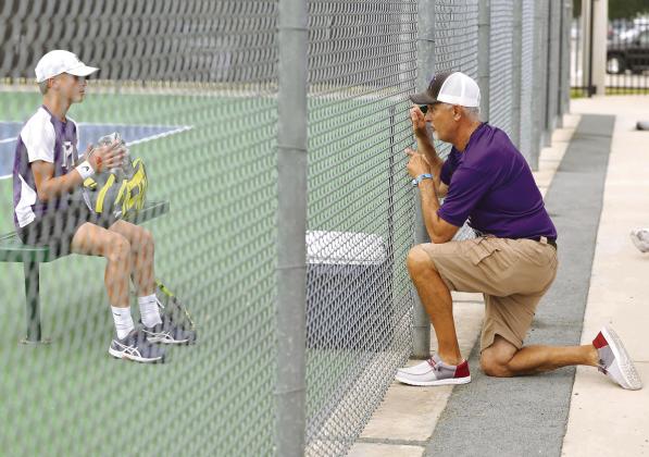 Marble Falls tennis head coach Samuel Whitley (right) talks to sophomore Cooper Womack before the start of the next game at the Class 4A state tournament.